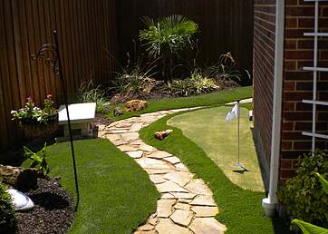 Golf putting green installed in the side yard
