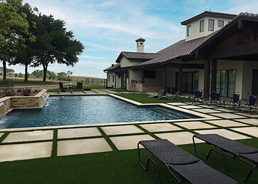 Synthetic grass installed as a pool surround in the backyard