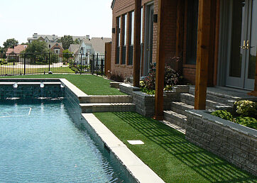 Synthetic turf around a backyard pool