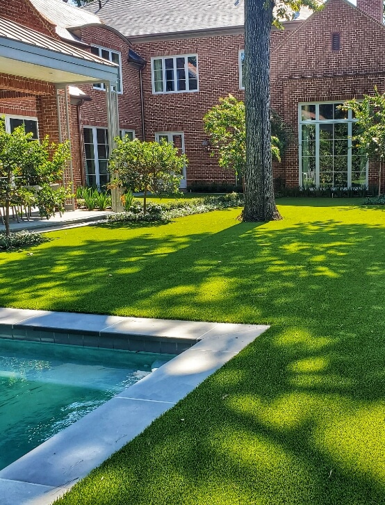 Arlington home with turf installed around a backyard pool